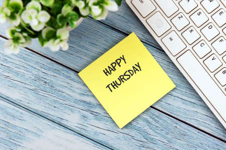 Happy Thursday on a adhesive paper note on office deskの写真素材