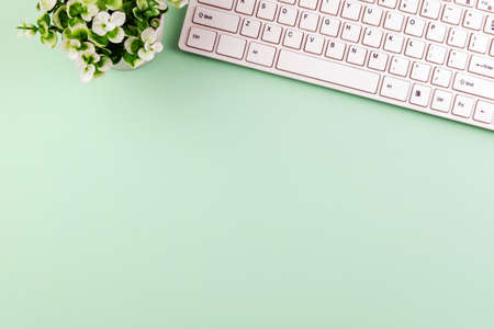 Office desk with computer keyboard with green background