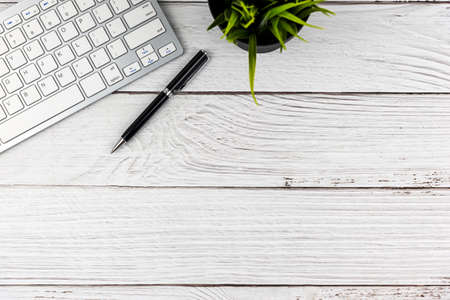 Flat lay office desk with computer keyboard and pen with copy space