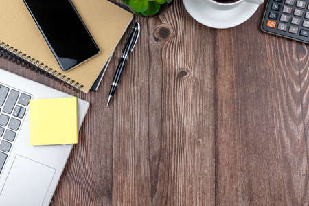 Directly above view of office desk with laptop, coffee and smart phoneの写真素材