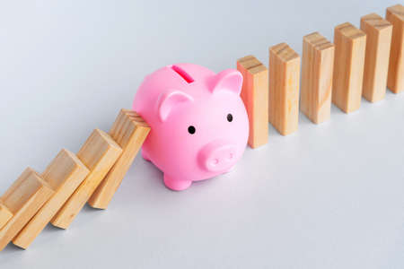 Piggy Bank and Domino Effect - Business and finance concept