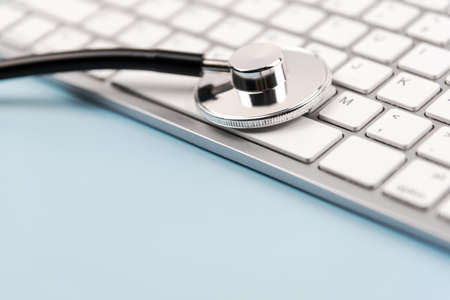 Close up of stethoscope on computer keyboard. Selective focus Health care concept with copy spaceの写真素材