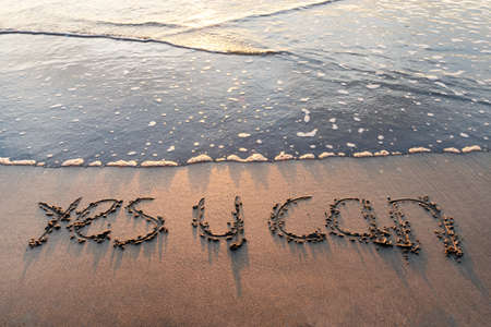 Yes you can text written on sand beachの写真素材