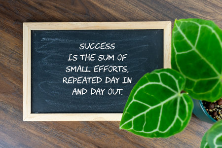 Inspirational quotes text Success is the sum of small efforts, repeated day in and day out written on mini chalk boardの写真素材
