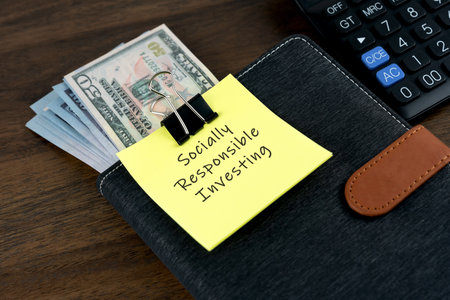 Socially Responsible Investing concept with financial bills and note pad