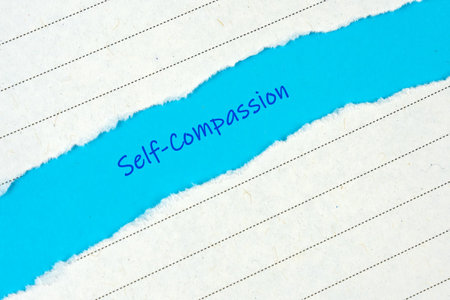 Self Compassion Text on Torn Paper - blue background