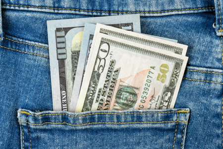 US paper currency in jeans pocket - business and financial concept