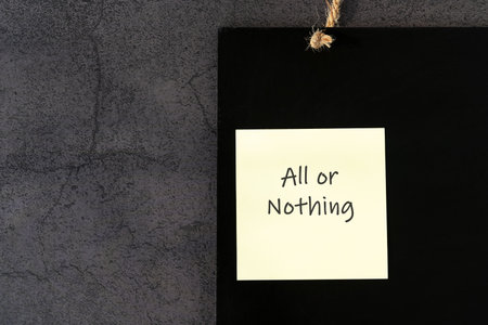 All or nothing text on adhesive noteの写真素材