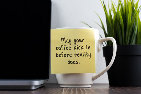 Sticky note of coffee mug with text - May your coffee kick in before reality does