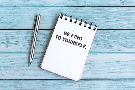 Notepad with text be kind to yourselfの写真素材