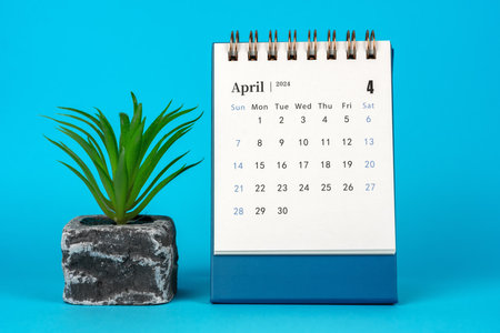 April 2024 Desk Calendar on Blue Backgroundの写真素材