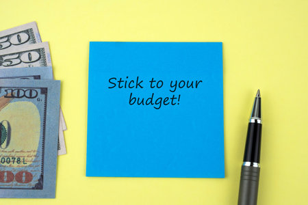 Adhesive note with text stick to your budgetの写真素材