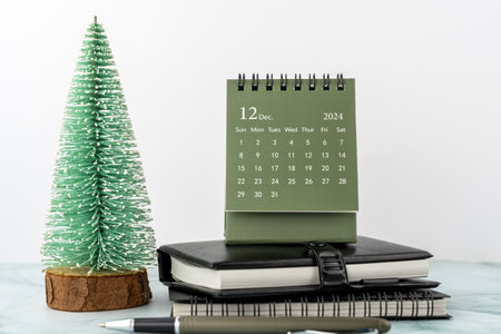 December 2024 desk calendar on top of tableの写真素材