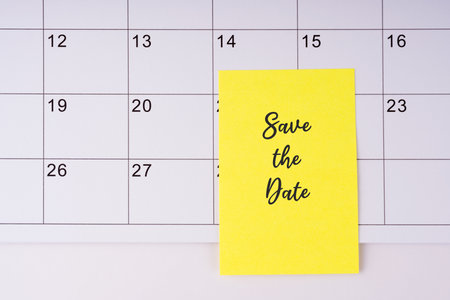 Save the date text on adhesive note on calendarの写真素材