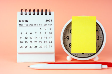 March 2024 Desk Calendar with alarm clock and adhesive noteの写真素材