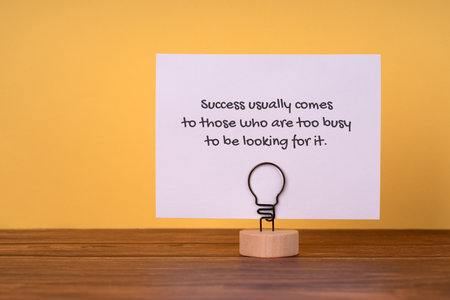 Paper note with inspirational quotes - Success comes to those who are too busy to be looking for itの写真素材