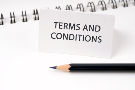 Terms and conditions on a paper note on blue backgroundの写真素材