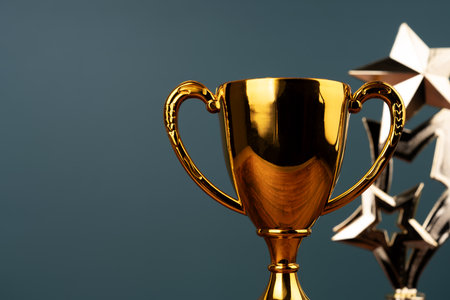 Close up of gold trophy on green backgroundの写真素材