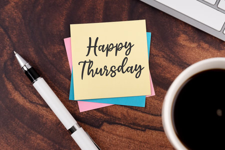 Happy Thursday greeting on adhesive note on wooden table