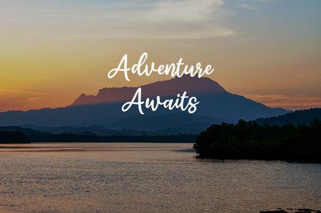 Sunrise landscape with inspirational quotes adventures awaitsの写真素材