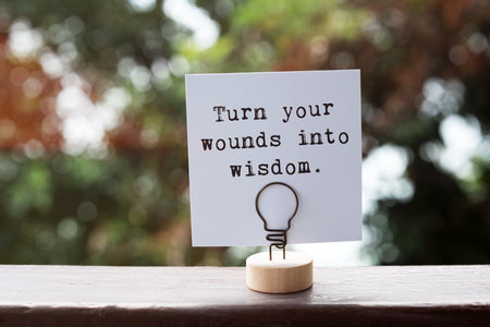 Paper note with inspirational quotes turn your wounds into wisdomの写真素材