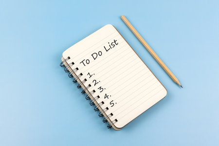 To do list text on notepad on blue backgroundの写真素材