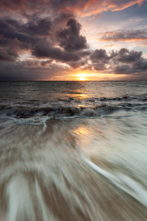 Sunrise and long exposure waves backgroundの写真素材