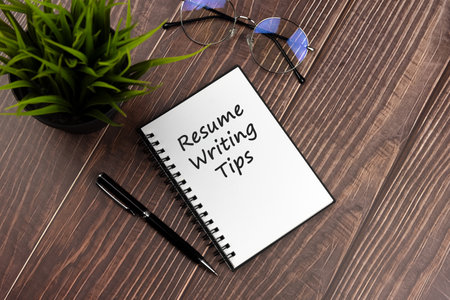 Resume writing tips text on notepad flat layの写真素材