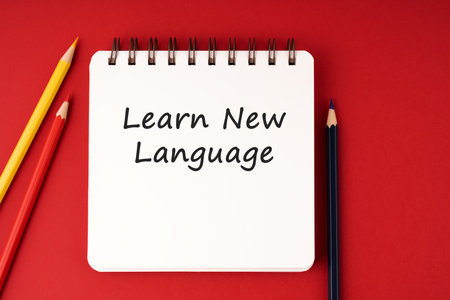 Learn new language text on notepad on red backgroundの写真素材