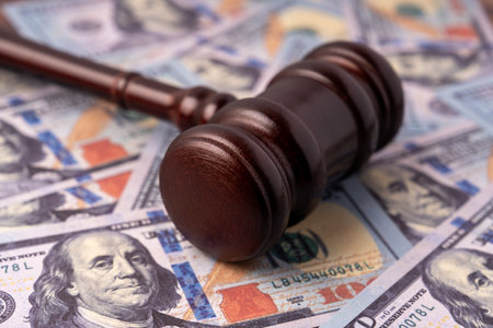 Close up of gavel on top of American 100 dollars money