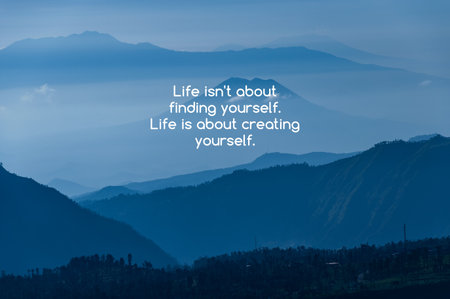 Blue layer mountain with background with inspirational quotes text life isn't about finding yourself life is about creating yourselfの写真素材