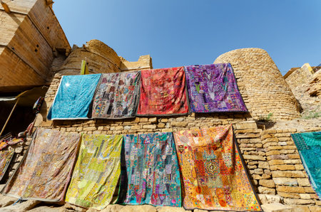 Colorful patchwork textiles or embroidered fabrics for sale in Jaisalmer fort, Rajasthan, India