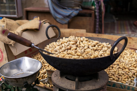 Roasting ground peanuts in an iron wok Mandawa India