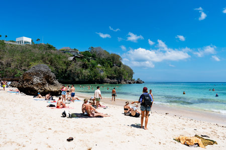 Uluwatu, Bali, Indonesia - September 01, 2025: Tourists sunbathing at Padang Padang Beach in Uluwatu, Bali, Indonesia.のeditorial素材