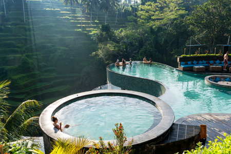 Ubud, Bali, Indonesia - August 21, 2025: Tourists relaxing in the infinity pool in Cretya Alas Harum at Tegallang Ubud Bali, Indonesiaのeditorial素材