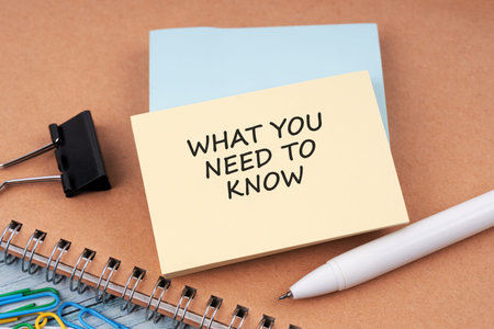 High angle view of paper note with text What you need to know
