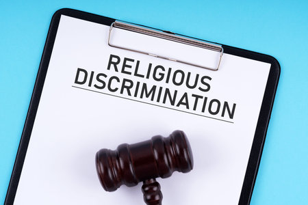 Religious discrimination document form and gavel set on blue background
