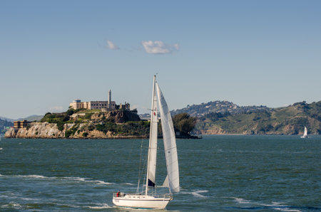SAN FRANCISCO, CALIFORNIA - MARCH 1, 2015: Catamaran an Sail Boat at San Francisco Bay on Alcatraz Island backgroundのeditorial素材