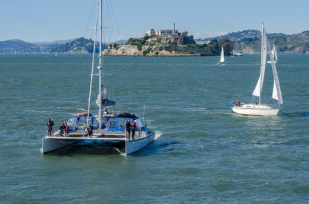 SAN FRANCISCO, CALIFORNIA - MARCH 1, 2015: Catamaran an Sail Boats at San Francisco Bay on Alcatraz Island backgroundのeditorial素材