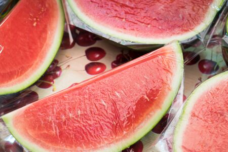 Sliced watermelon covered with thin protective tape for sale at Jerusalem city market
