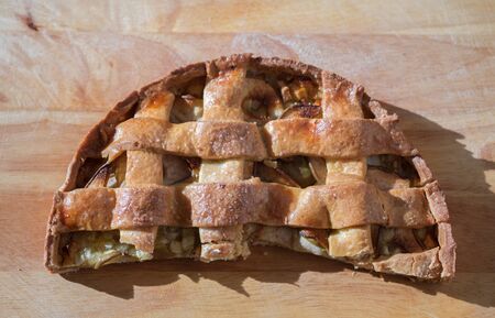Macro photography of tasty pear tart on wood cutting boardの写真素材