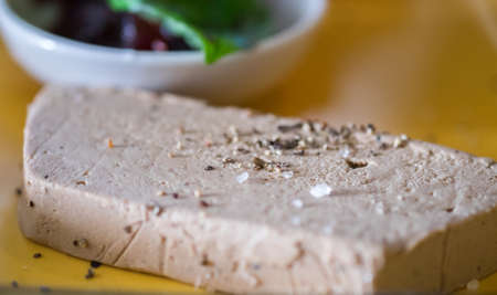Liver pate served with onions jam on yellow tray