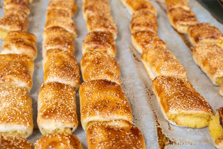 Small boreks Ð¾Ñ bourekas with sesame seeds sold in a bakery storeの写真素材