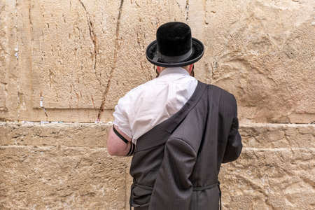 Undefined ultra-orthodox jewish person prays next to Western Wall in Jerusalem. Israelの写真素材