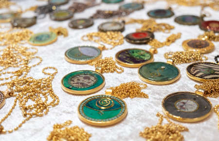 Handmade medallions or pendants for sale at handicraft marketの写真素材