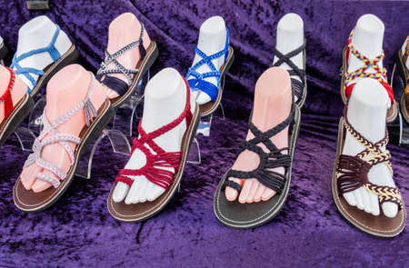 Colorful women sandals for sale at shoe store or street marketの写真素材