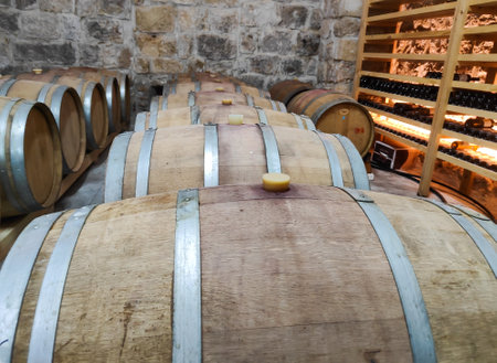 Wooden wine barrels in the old cellar of the wineryの写真素材