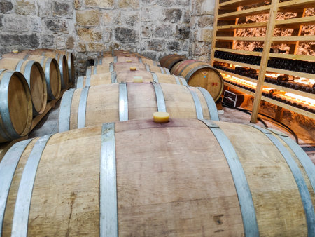 Wooden wine barrels in the old cellar of the wineryの写真素材