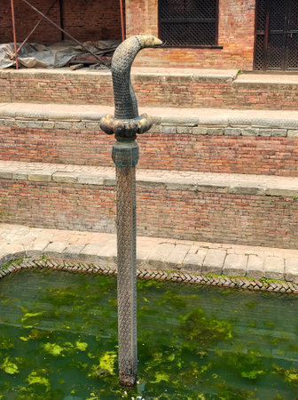 The bronze cobra statue at a temple at Patan Durbar Square, a historical site in Lalitpur district. Nepalの写真素材