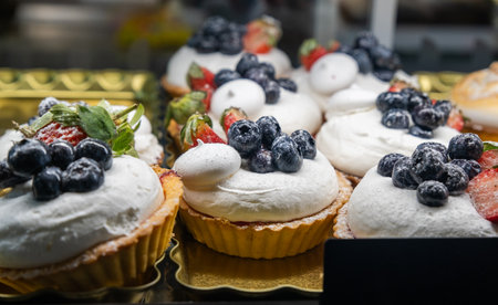 Tartelettes with strawberries and blueberries sold at a sweets store in Europeの写真素材